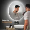 A man is shaving in front of a round LED mirror in a modern bathroom. Anteprima dell’immagine prodotto