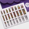 A set of knitting needles laid out in a white case, with a purple fabric case in the background. Produktbild-Vorschau