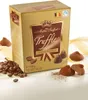 A box of Maitre Truffout Fancy Gold Truffles with coffee beans and truffles scattered around it. Náhľad obrázku produktu