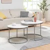 A living room scene with a couch and two round coffee tables. Voir les images du produit
