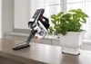A cordless vacuum cleaner is shown on a kitchen counter next to a potted plant. Anteprima dell’immagine prodotto