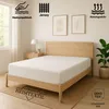 A white jersey fitted sheet on a wooden bed frame in a bedroom setting. Produktbild-Vorschau