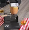 A raclette grill with a half-wheel of cheese melting, next to glasses of white wine and a checkered tablecloth. Produktbild-Vorschau