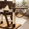 A close-up view of a multi-level cat tree with scratching posts and a hammock, set in a living room with natural light. Produktbild-Vorschau