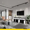 A modern living room with a TV console, armchair, and coffee table. Voir les images du produit