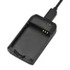 A black portable mini charger with a USB charging cable plugged in, shown against a white background. Produktbild-Vorschau