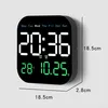 A digital wall clock displaying time, date, and temperature, with dimensions indicated. Produktbild-Vorschau