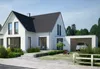 A modern white house with a garage and a car, surrounded by greenery and a blue sky. Produktbild-Vorschau