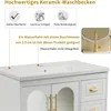 A close-up view of a white ceramic washbasin with a white cabinet underneath, featuring gold handles and decorative glass doors. Text overlays highlight product features and compatibility. Produktbild-Vorschau