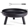 A black metal fire pit with three legs and a poker tool above it, presented on a white background. Náhled obrázku produktu