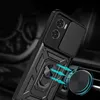 A close-up shot of a black phone case with a sliding camera cover and a ring holder, attached to a magnetic car mount. Podgląd zdjęcia produktu