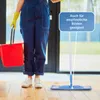 A person in blue overalls and yellow gloves is holding a red bucket and a mop, standing on a wooden floor. Produktbild-Vorschau