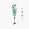 A mint green Bamix immersion blender with silver accents is displayed on a white background, accompanied by line drawings of its various attachments. Náhled obrázku produktu