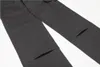 A close-up view of dark gray cargo pants, showing the pockets and seams. Produktbild-Vorschau