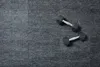 Two dumbbells are placed on a textured gray surface. Produktbild-Vorschau