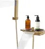 A gold-colored waterfall faucet and hand shower set for a bathtub, with two bottles of toiletries on a shelf. Podgląd zdjęcia produktu