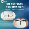A marketing image showcasing a white basin with a black faucet, presented in two circular insets against a blue and gray gradient background with text. Produktbild-Vorschau