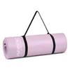 A rolled-up pink yoga mat with black straps and a black carrying strap, shown against a white background. Anteprima dell’immagine prodotto