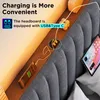 A close-up view of a bed headboard with integrated charging ports and a tablet. Anteprima dell’immagine prodotto