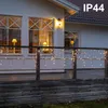 A house deck at dusk with icicle lights strung along the railing. Podgląd zdjęcia produktu