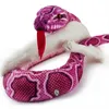 A close-up shot of a pink python plush toy coiled around a white object, with its red tongue sticking out. Produktbild-Vorschau