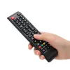 A hand holding a black TV remote control. Náhľad obrázku produktu