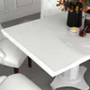 A white dining table with a glossy finish, set with a small dish of butter and a glass of iced tea with a sprig of mint. Produktbild-Vorschau