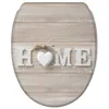 A toilet seat with a wood-like pattern and the word "HOME" spelled out with letters and a heart. Produktbild-Vorschau