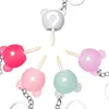 A collection of lip glosses shaped like bear heads, arranged in a circular pattern against a white background. Podgląd zdjęcia produktu