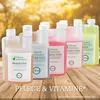 Several bottles of liquid supplements for chickens are arranged on a wooden surface with a blurred background of trees and sunlight. Produktbild-Vorschau