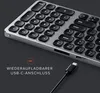 A close-up view of a silver and black Satechi Compact Backlit Bluetooth Keyboard, with a USB-C cable and text overlay. Anteprima dell’immagine prodotto