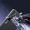 A smartphone camera lens is shown breaking apart, with shards of glass flying off, against a dark background. A large, faceted, transparent object, also appearing to be breaking, is in the foreground. Produktbild-Vorschau