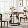 A round dining table set in a dining room with chairs, a vase of flowers, and decorative items on a sideboard. Náhľad obrázku produktu
