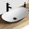 A modern white and black vessel sink with a black faucet on a wooden countertop. Anteprima dell’immagine prodotto