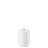 A white LED candle with a lit flame. Produktbild-Vorschau