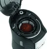 A close-up view of the inside of a black coffee maker, showing the filter basket filled with coffee grounds. Produktbild-Vorschau