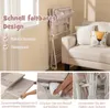 A baby changing table is shown in a room with a sofa and a window. Produktbild-Vorschau