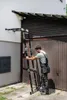 A man is using a multi-purpose ladder next to a garage door. Náhľad obrázku produktu