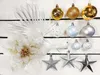A collection of Christmas ornaments and decorations arranged on a white wooden surface. Podgląd zdjęcia produktu