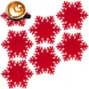 A set of red snowflake-shaped coasters with a cup of coffee on one of them. Náhled obrázku produktu