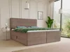 A boxspring bed with two storage drawers is shown in a bedroom setting with a large window overlooking a forest. Produktbild-Vorschau