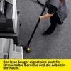 A person is vacuuming a carpeted floor next to office equipment. Voir les images du produit