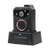 A black body camera is shown on a black charging dock against a white background. Produktbild-Vorschau