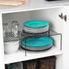 A cabinet shelf filled with kitchenware, including plates, bowls, and glasses. Podgląd zdjęcia produktu