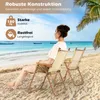 Two people sitting on beach chairs on a sandy beach with the ocean and palm trees in the background. Produktbild-Vorschau