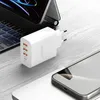 A white USB charger with multiple ports is placed on a wooden surface next to a laptop and a smartphone. Podgląd zdjęcia produktu