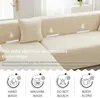A sectional sofa with cream-colored slipcovers, demonstrating foam strips to secure the covers in place. Below the sofa image are four icons representing washing instructions. Náhled obrázku produktu