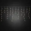 A string of LED icicle lights hanging against a dark background. Produktbild-Vorschau