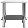 A modern side table with a transparent glass top and a black glass shelf, supported by four polished silver legs. Produktbild-Vorschau