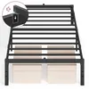A black metal bed frame with beige storage boxes underneath, shown from a slightly elevated angle. Produktbild-Vorschau